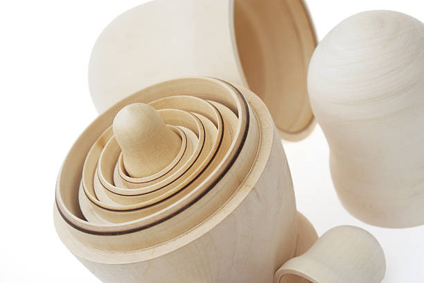 Unpainted Matryoshka dolls on white.